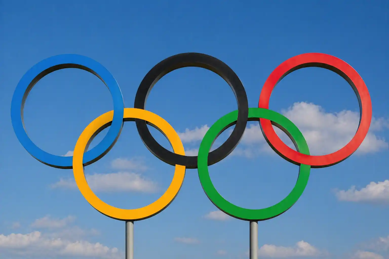 The Olympic rings displayed on Tower Bridge over the River Thames at dusk — the UK has hosted the Summer Olympics three times.
